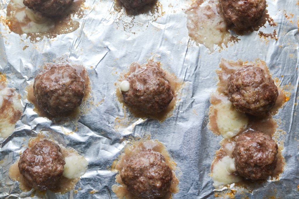 cooked meatballs on a baking sheet