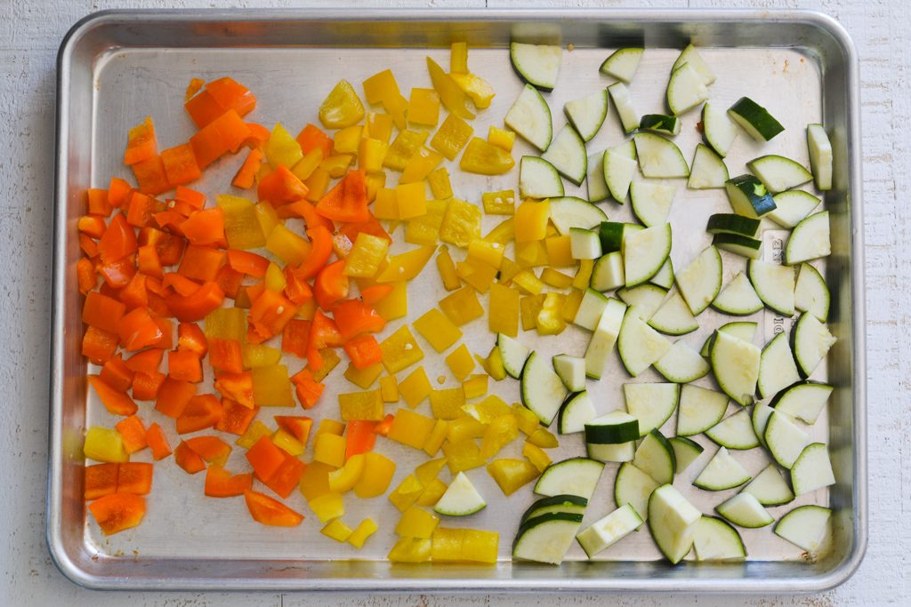 zucchini and peppers on a sheet pan
